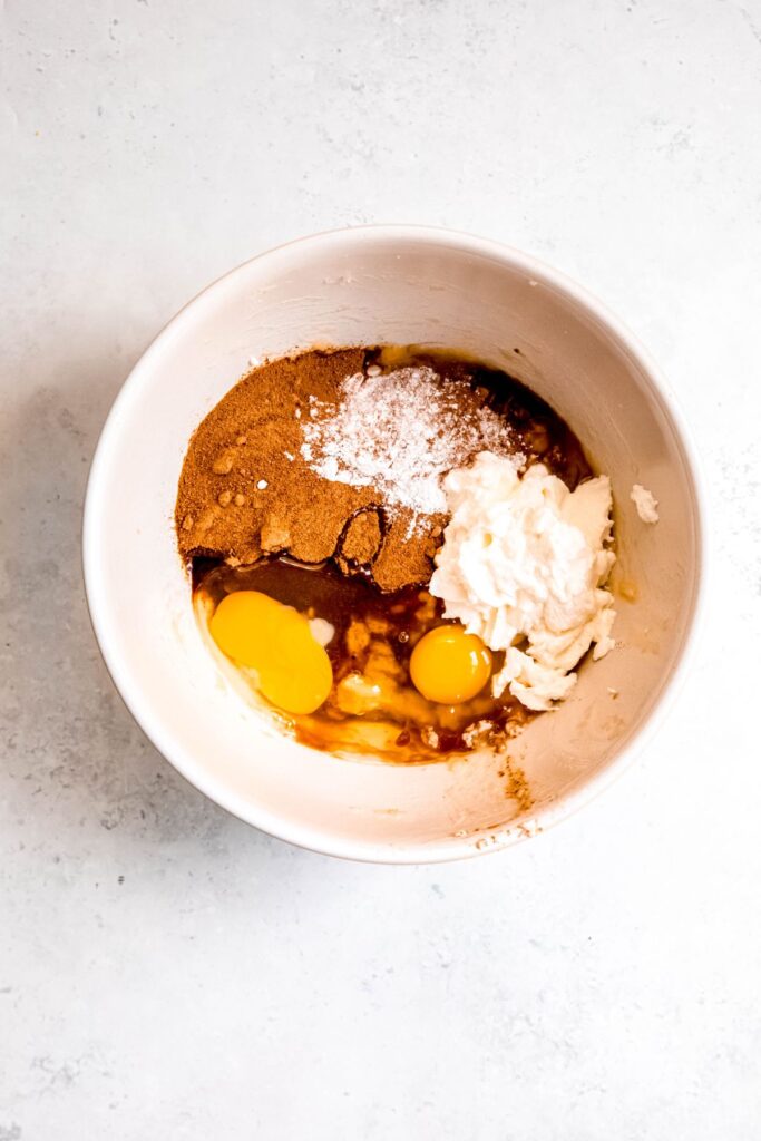 eggs, yogurt, coconut sugar, and vanilla extract added to the bowl.