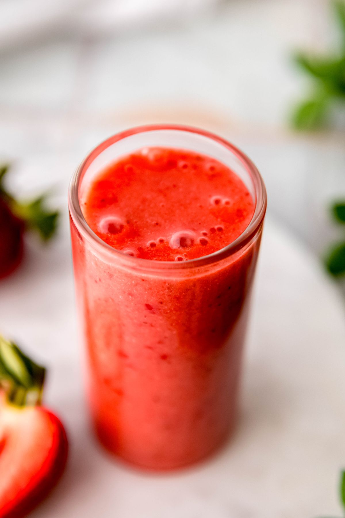 A close-up angled shot of a small cup of the easy strawberry vinaigrette.