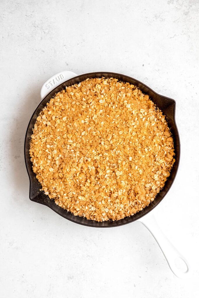 baked blackberry crisp on a white table.