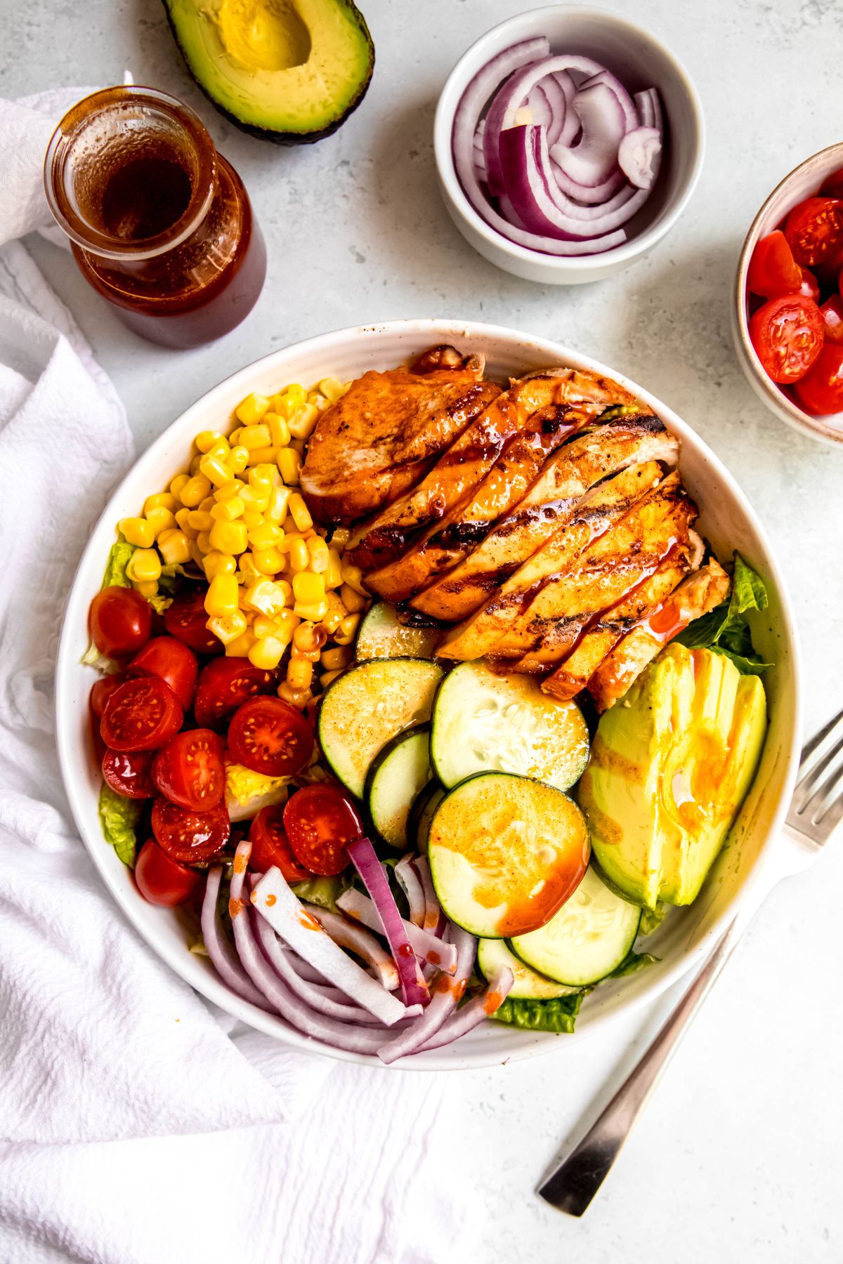 flat lay shot of hot honey chicken salad after drizzling on the hot honey vinaigrette.