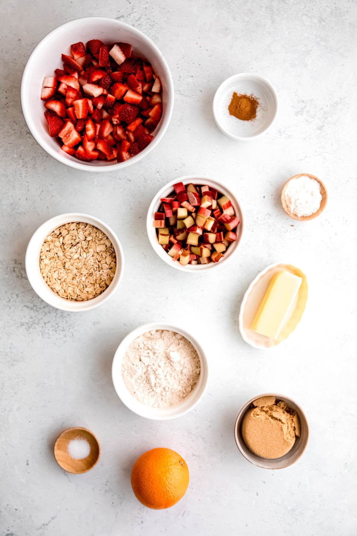 All the ingredients to make strawberry rhubarb crisp on the counter.