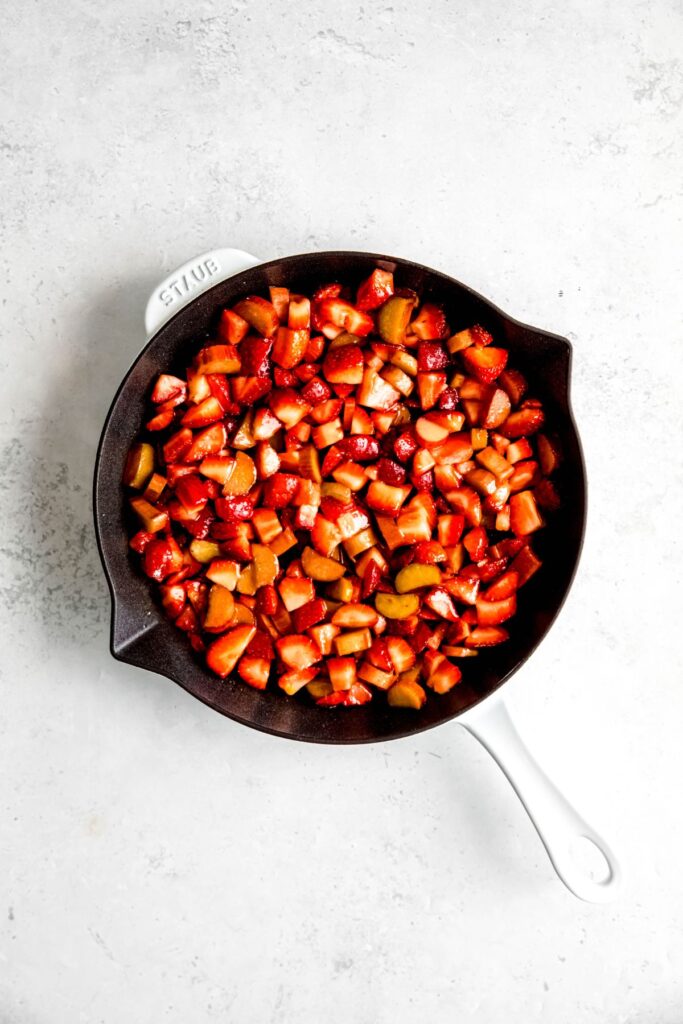 A large skillet of the strawberry and rhubarb mixture before topping.