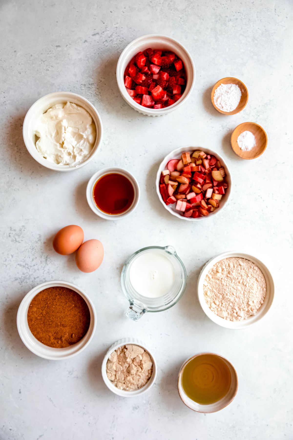 The ingredients needed to make strawberry rhubarb protein muffins.