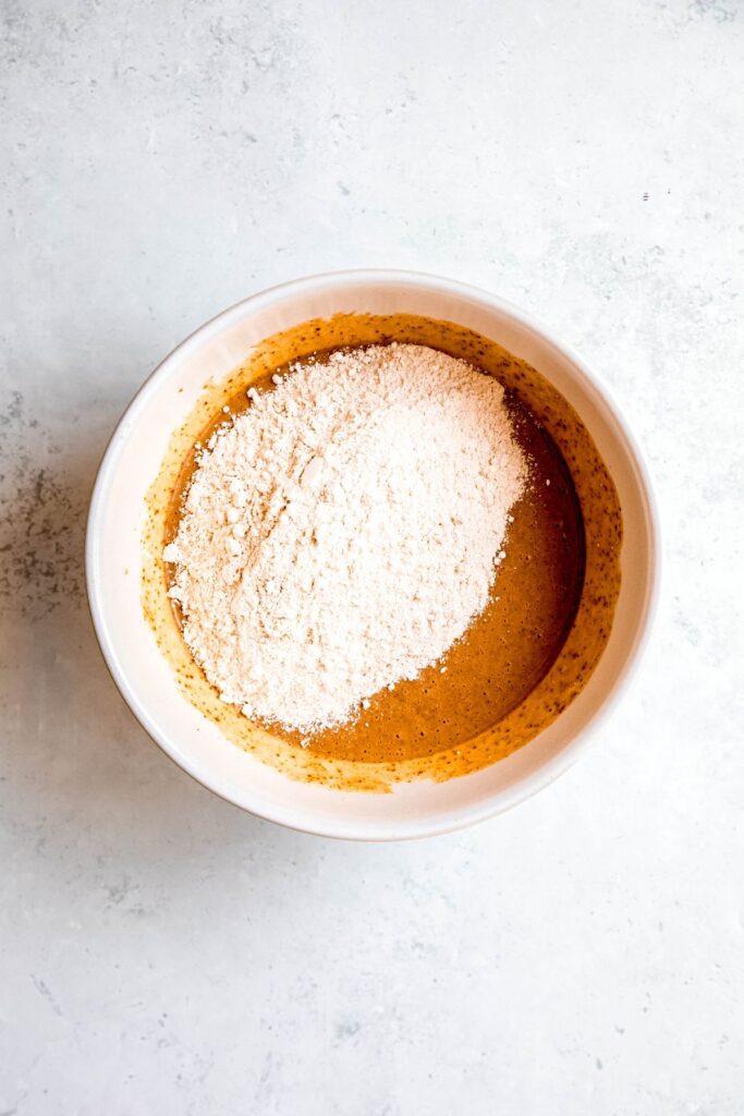 The wet and dry ingredients in a mixing bowl.