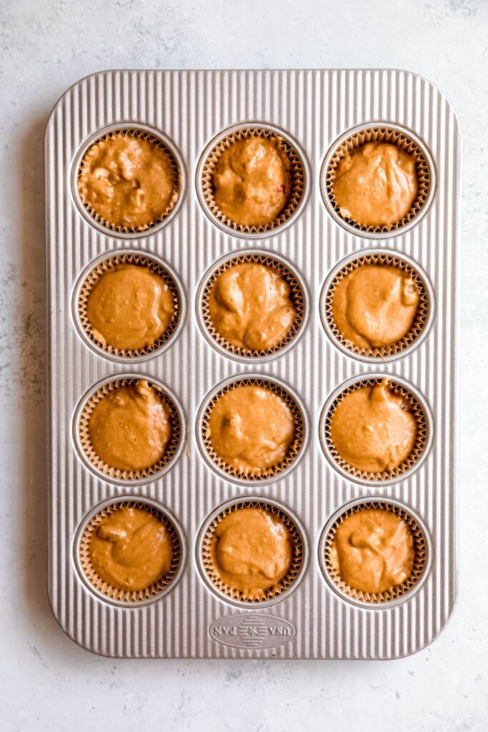 The pan of strawberry rhubarb muffins before baking.