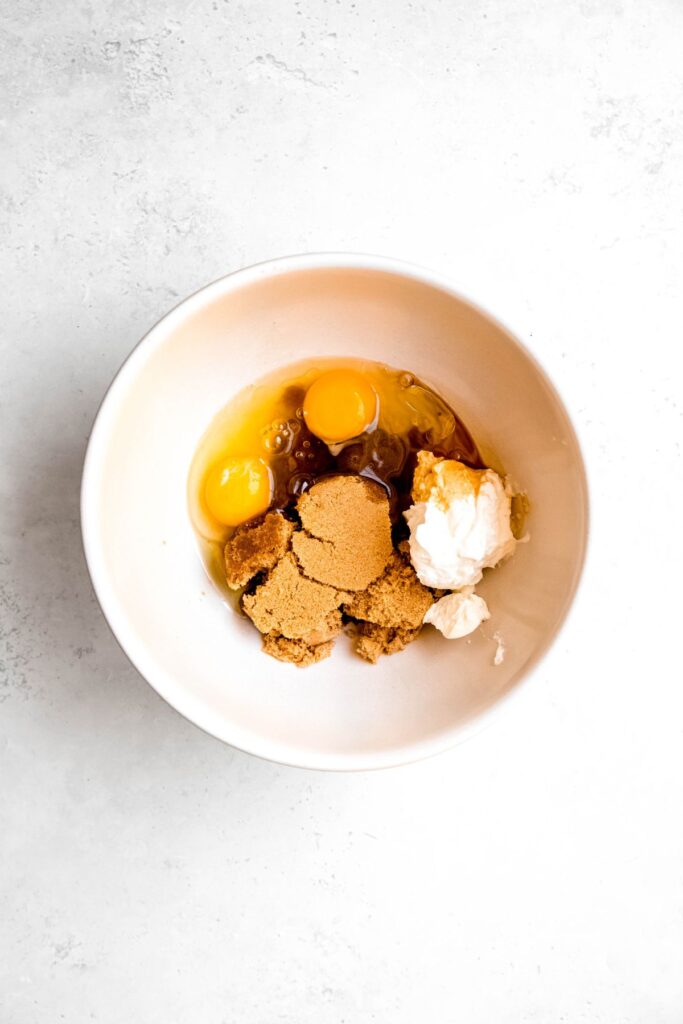 eggs, oil, yogurt, coconut sugar, and vanilla extract added to a separate mixing bowl.