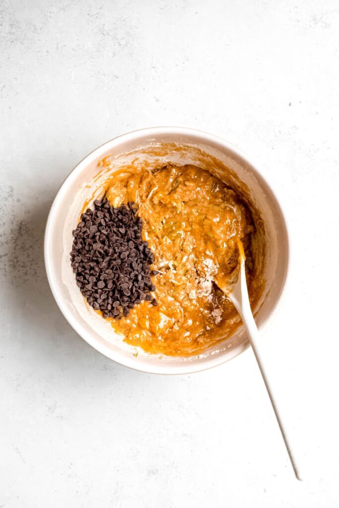 A mixing bowl of the zucchini bar batter with mini chocolate chips.