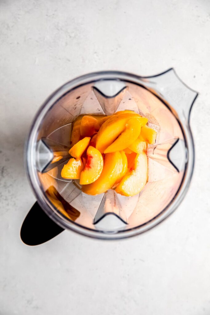 peaches, lemon juice, sugar, and water added to a blender.