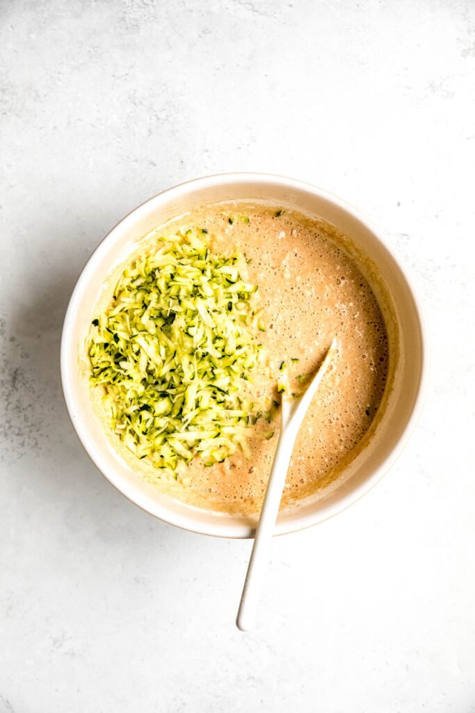 shredded zucchini added to the bowl with the protein pancake batter.