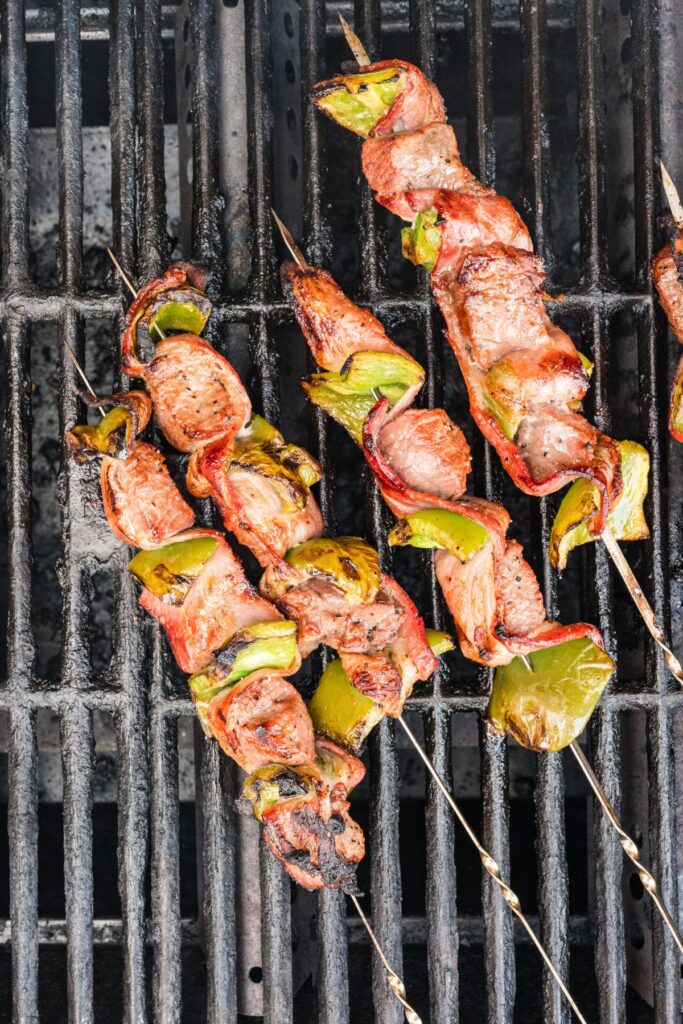 grilled bacon and beef skewers on the grill after basting and flipping a second time.