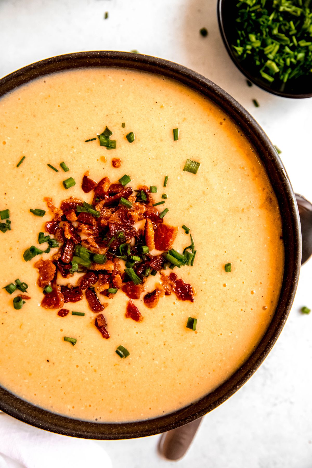 A close-up overhead shot of a bowl of the high-protein creamy potato soup.