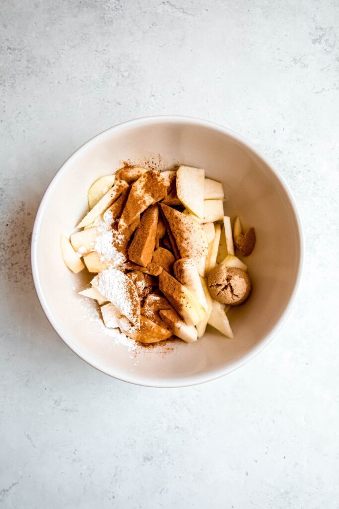 pear crisp filling ingredients added to a mixing bowl.