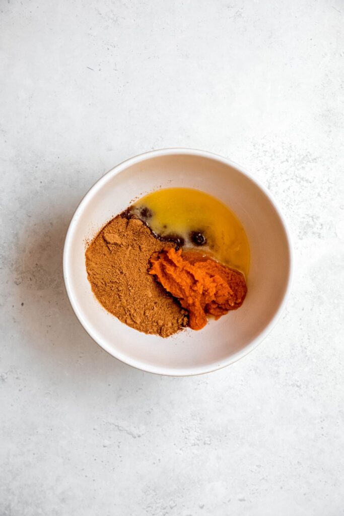 coconut sugar, melted butter, and pumpkin purée added to a mixing bowl.