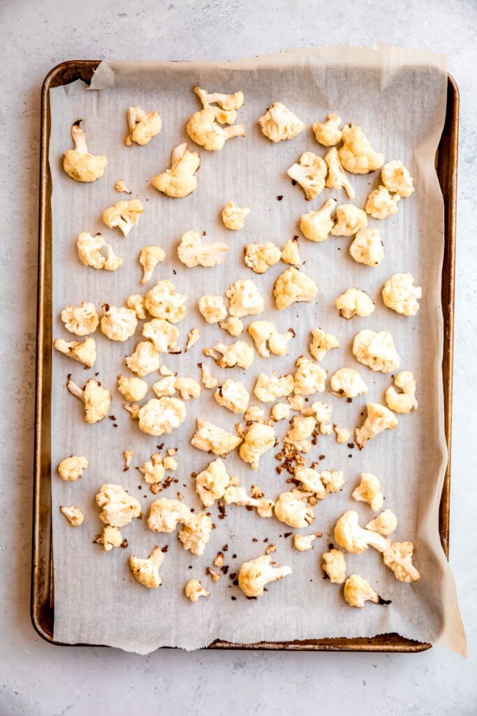 crispy cauliflower bites after the first bake.