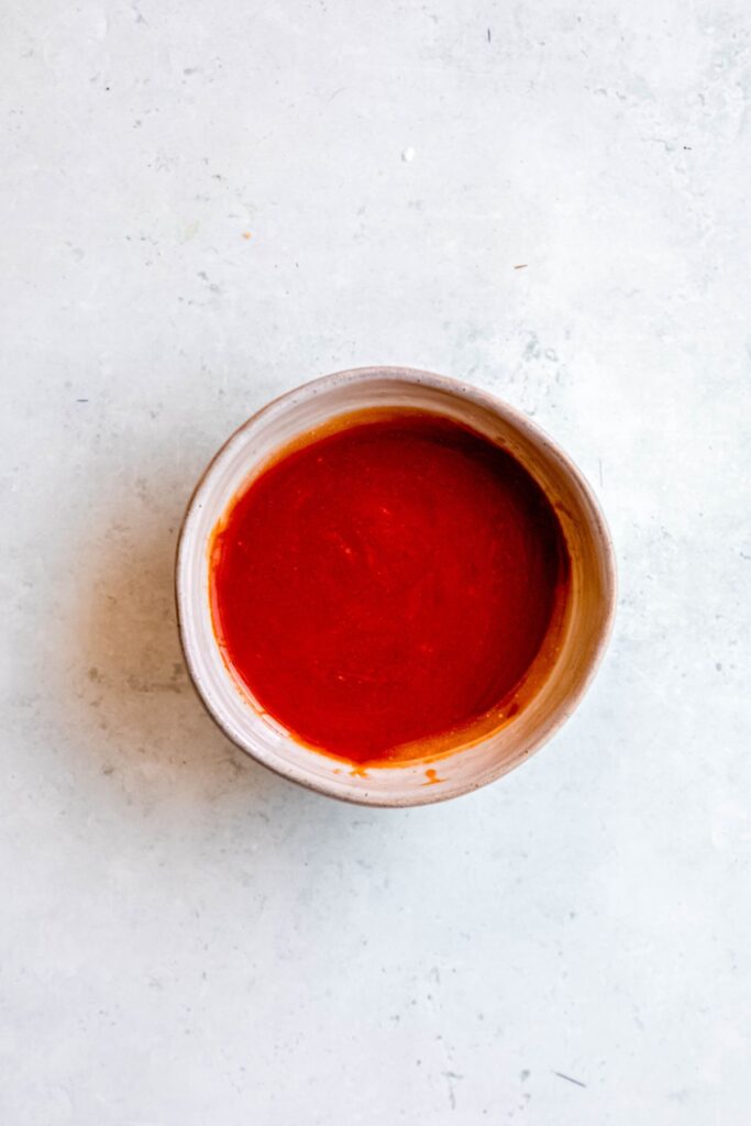 mixing bowl with the buttery buffalo wing sauce mixture.