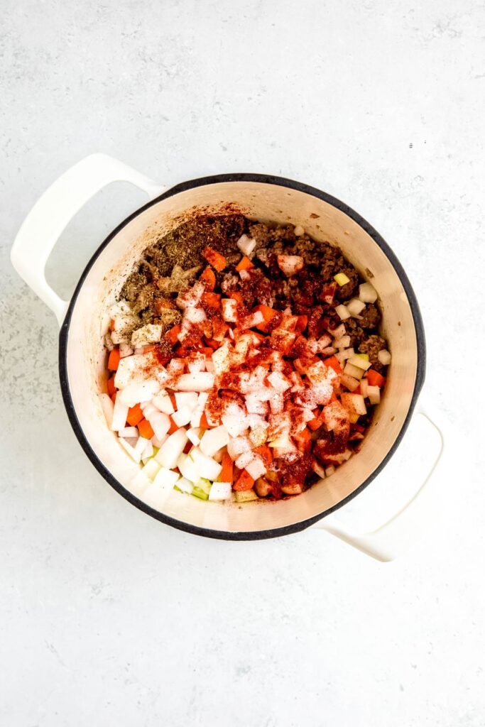aromatics (mirepoix) and seasoning added to the pot with the beef.