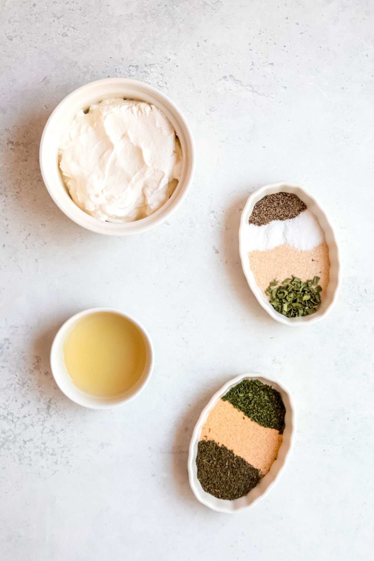 All the ingredients needed to make healthy, herby Greek yogurt ranch dressing on the counter.