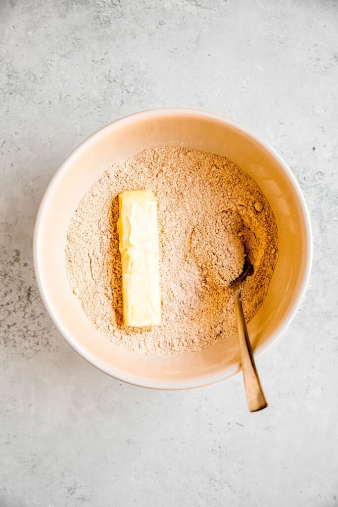 stick of butter added to the bowl with the dry crumble/crust ingredients.