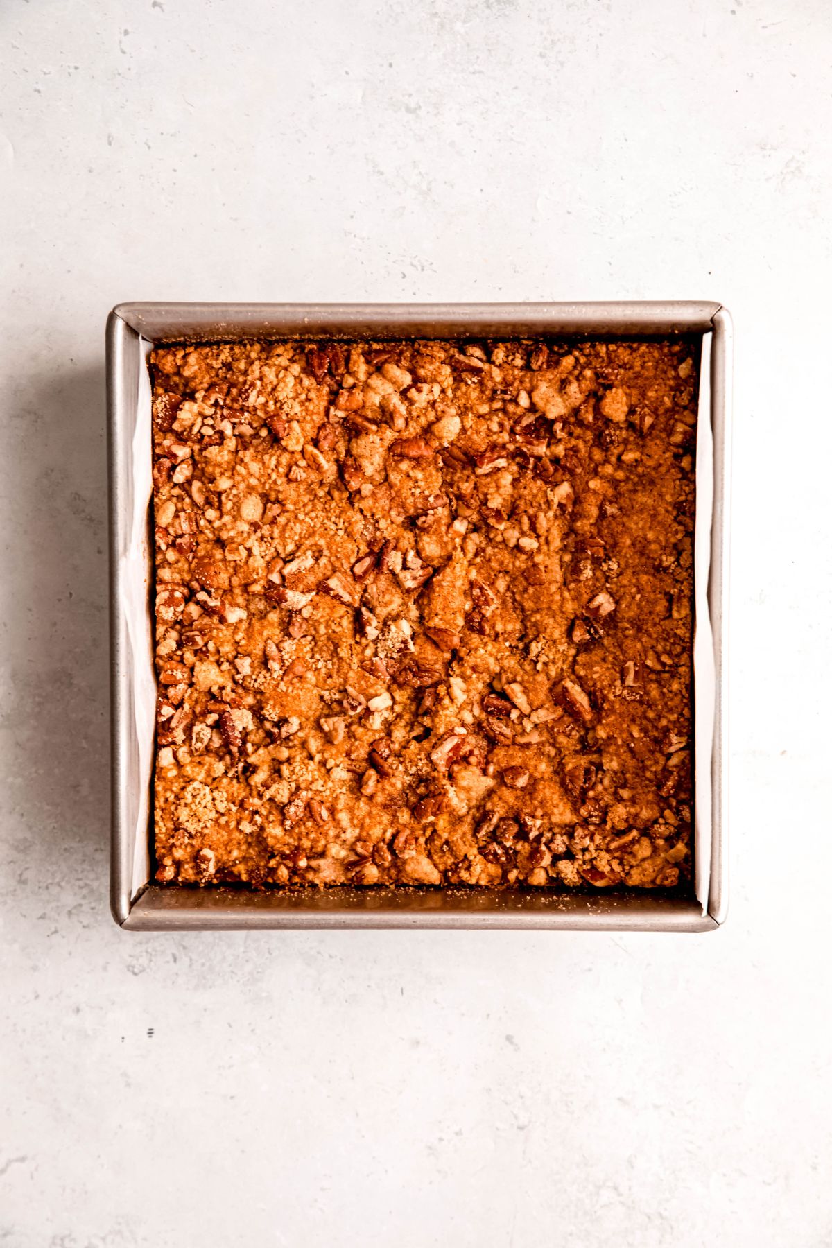 pumpkin pie crumble bars in the tin after baking.