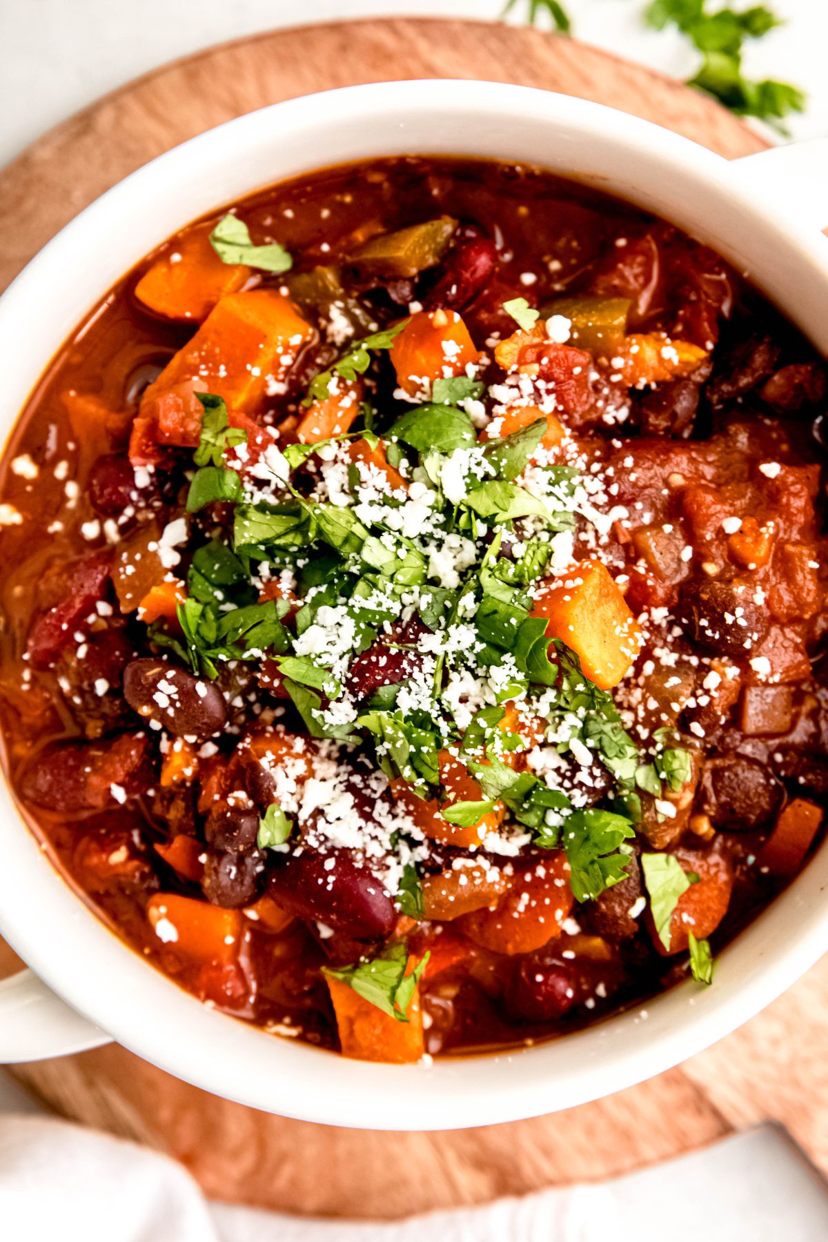 A close-up overhead shot of a crock of sweet potato black bean chili.