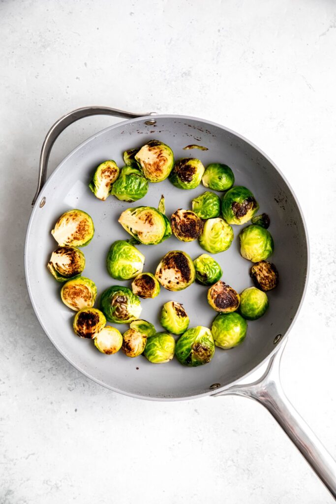 brussels sprouts in the skillet after browning the cut halves.