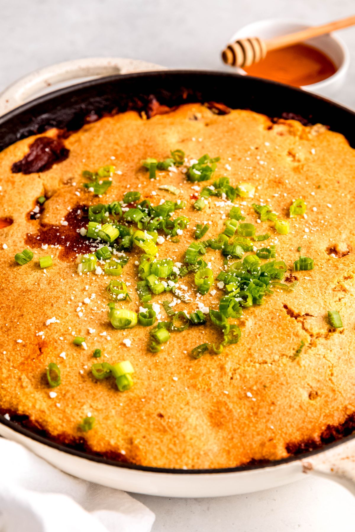 A close-up angled shot of a pan of the chili cornbread casserole.