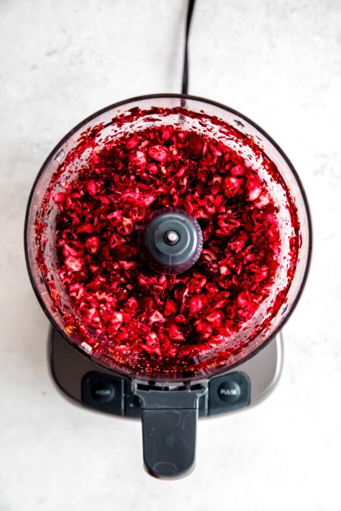 cranberries roughly chopped in the base of a food processor.
