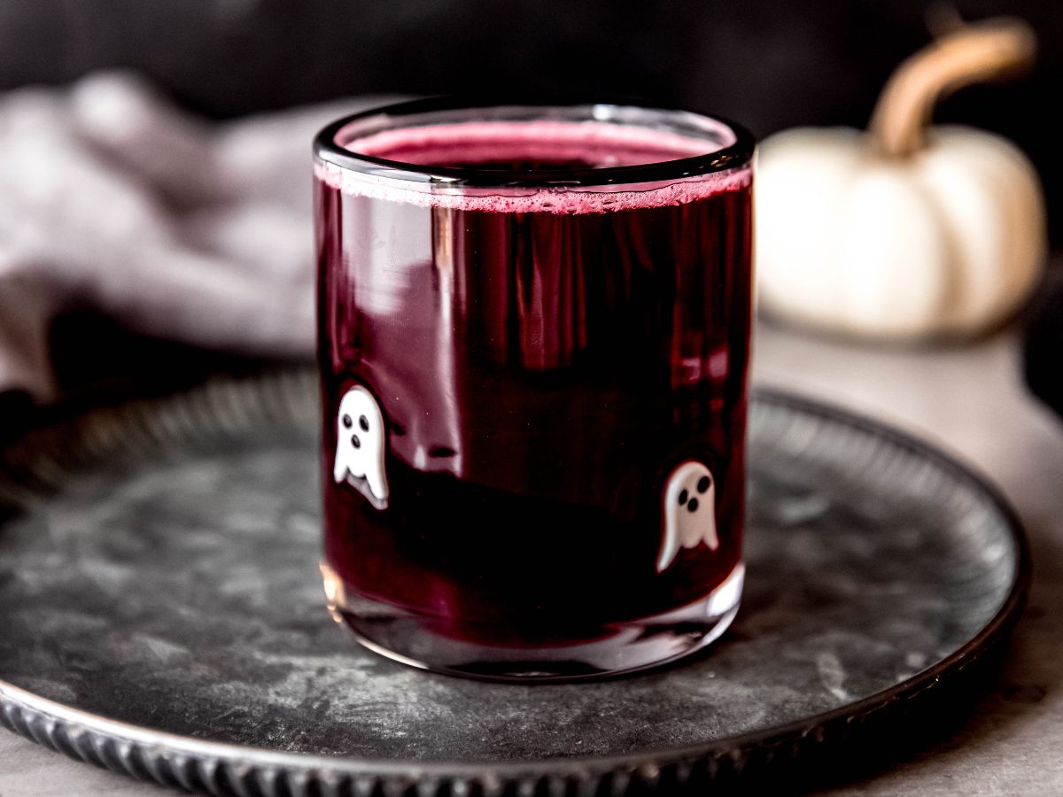 A horizontal shot of a small cup of witches brew halloween lemonade (non-alcoholic).