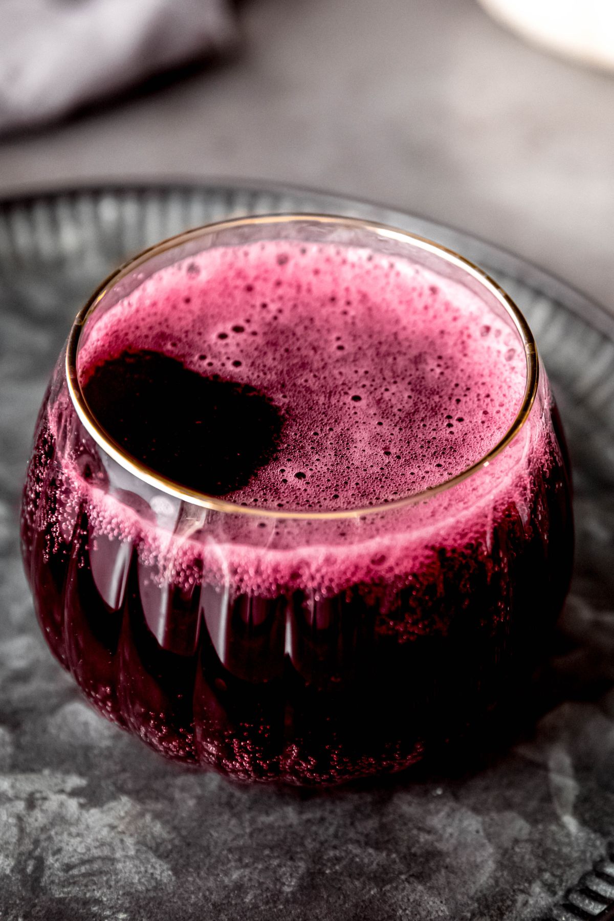A close-up shot of a glove-like glass of the witches brew lemonade.