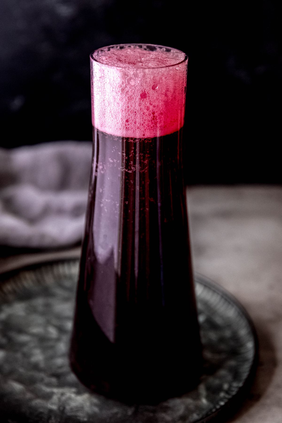 A close-up, slightly elevated shot of a carafe of the bubbly Halloween lemonade (witches brew-style!).