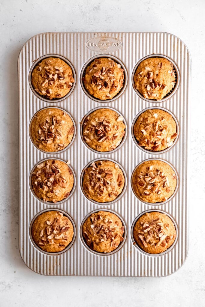 baked pecan pie muffins in the muffin tin to cool.