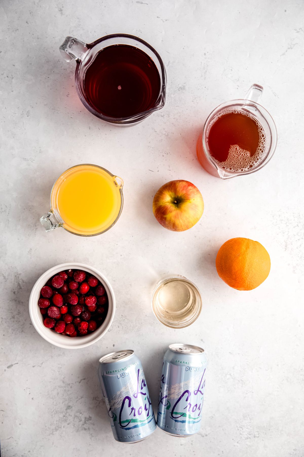 ingredients needed to make non alcoholic Thanksgiving punch recipe measured out on a white table.