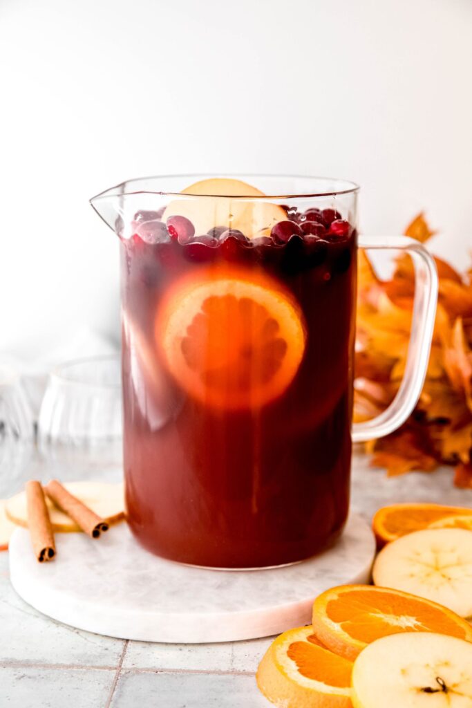 Thanksgiving punch in a pitcher after adding the fresh fruit.