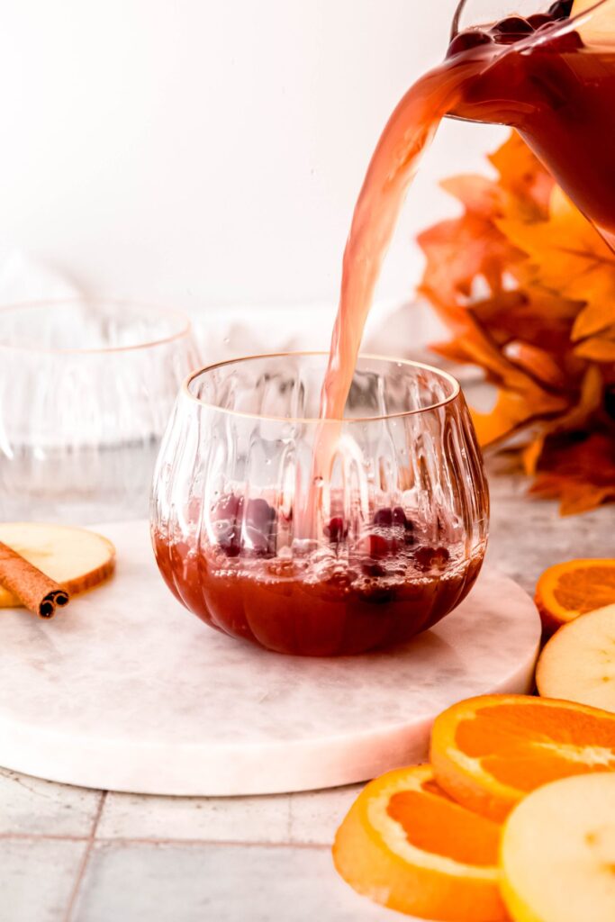 action shot of a punch glass being filled with the non-alcoholic Thanksgiving fruit punch.