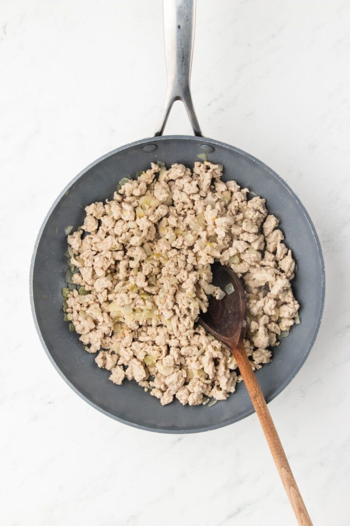 ground turkey browning in a skillet with onions.