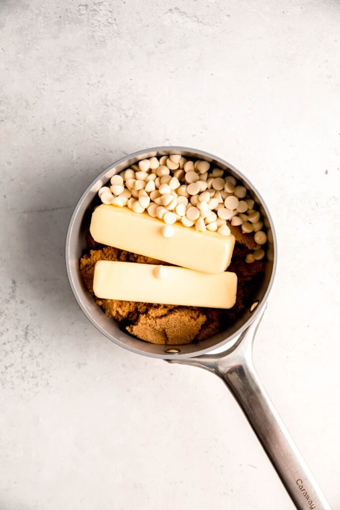 butter, white chocolate chips, and brown sugar added to a saucepan.