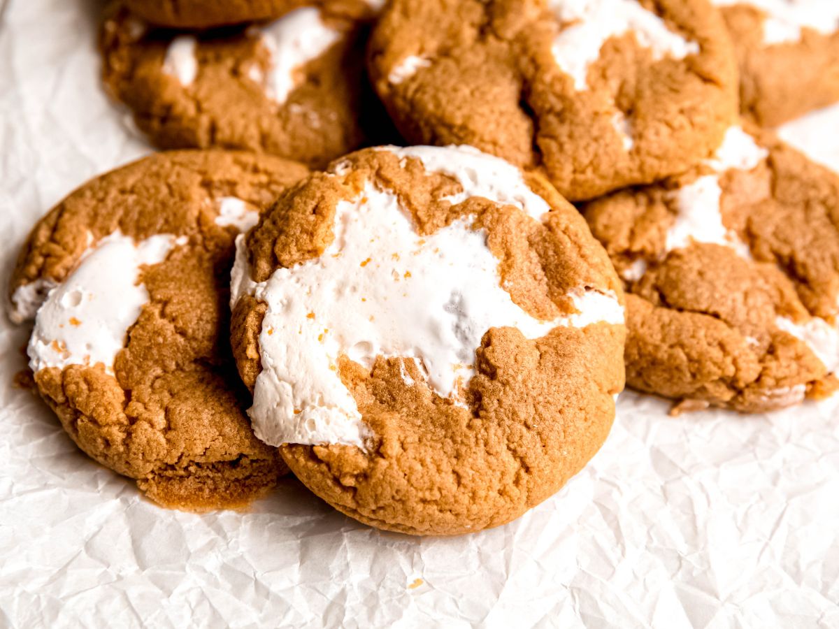 horizontally framed hero shot of fluffernutter cookies on a white piece of parchment paper.