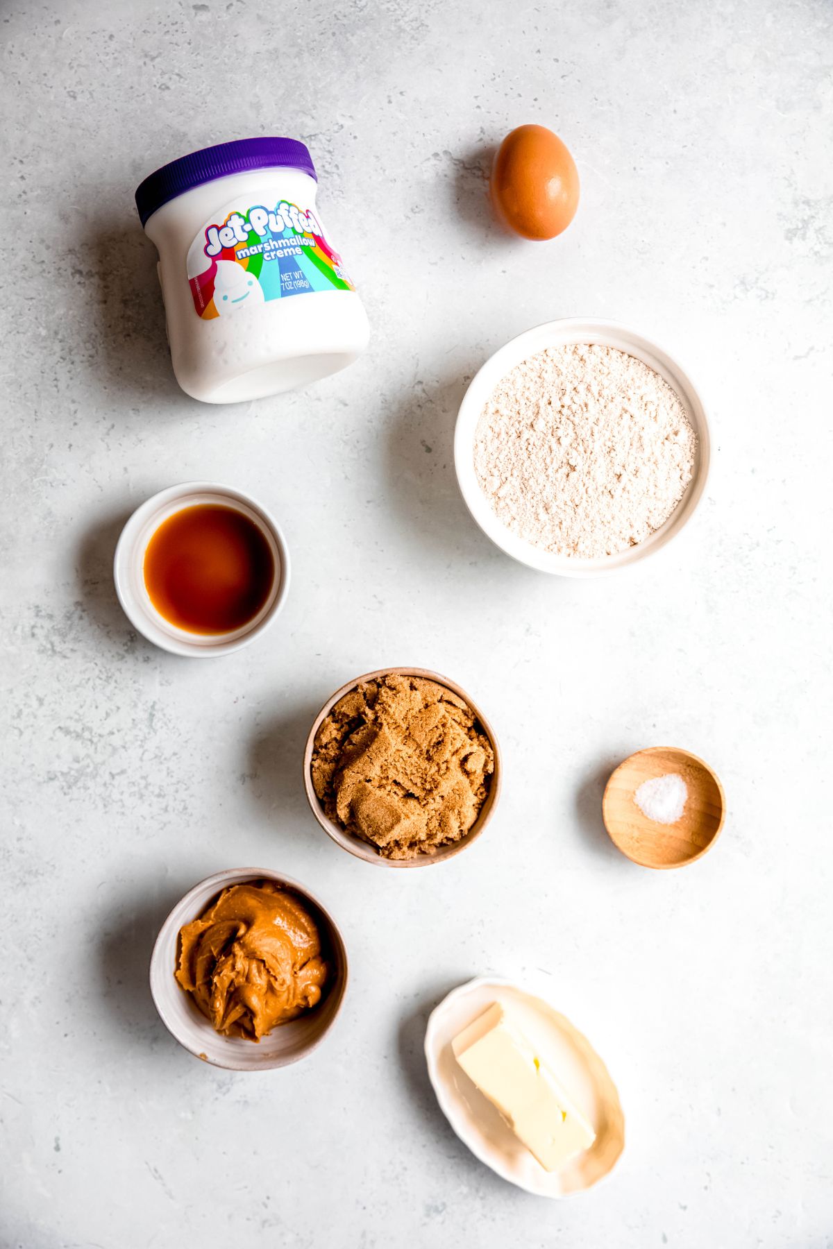 ingredients needed to make whole wheat fluffernutter cookies recipe measured out on a white table.