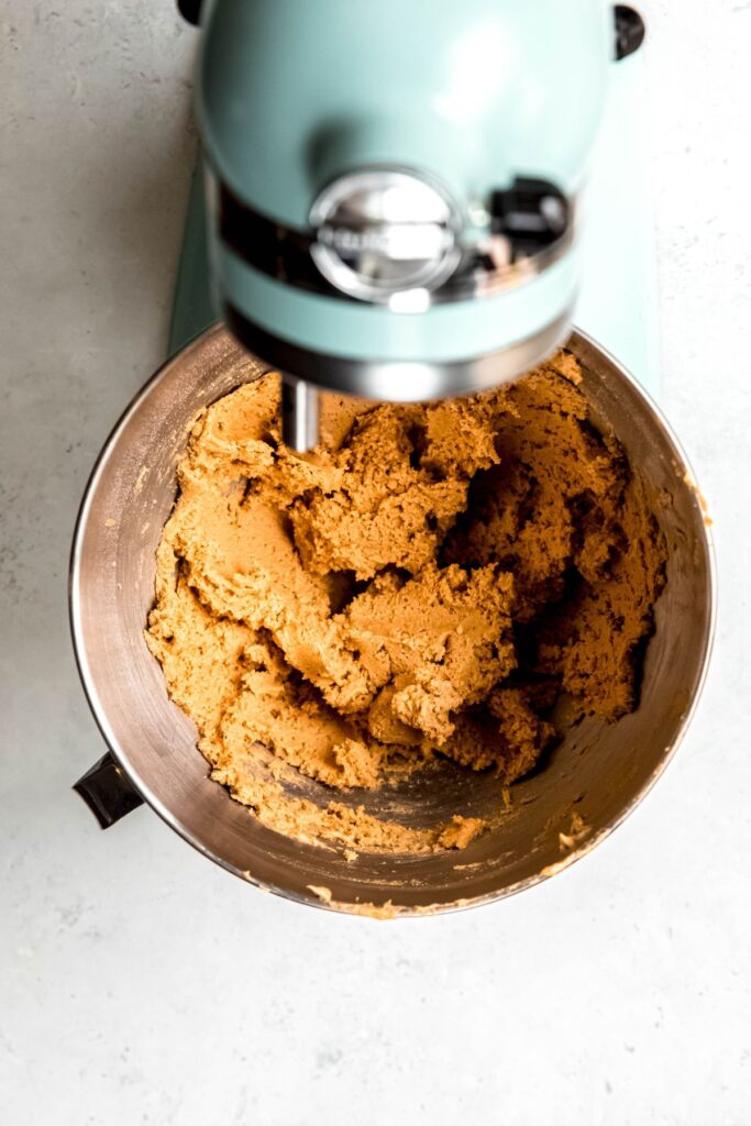 peanut butter cookie dough in the base of a stand mixer.