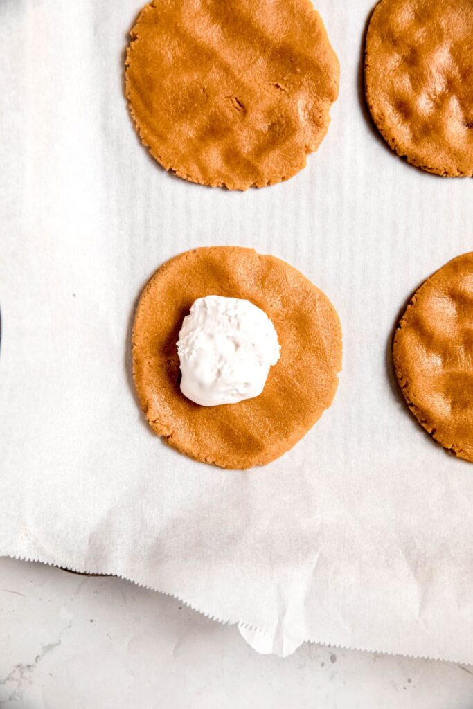 dollop of marshmallow fluff added to the middle of the peanut butter cookie.