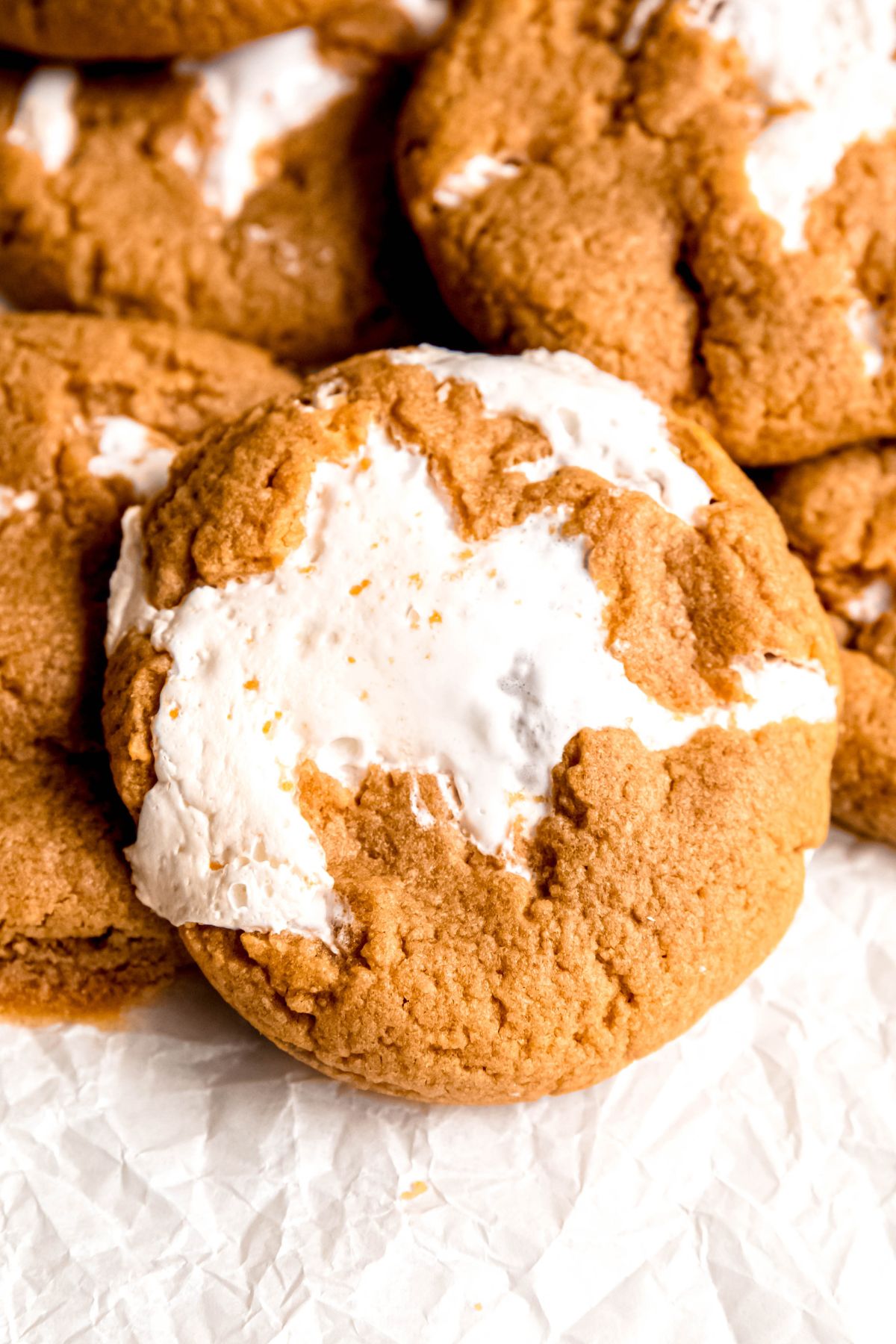 closeup overhead shot of a gooey peanut butter marshmallow fluff cookie at the top of a pile.