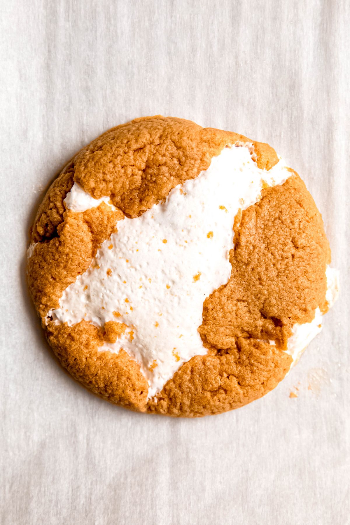 closeup overhead shot of a single fluffernutter cookie with marshmallow fluff and peanut butter.