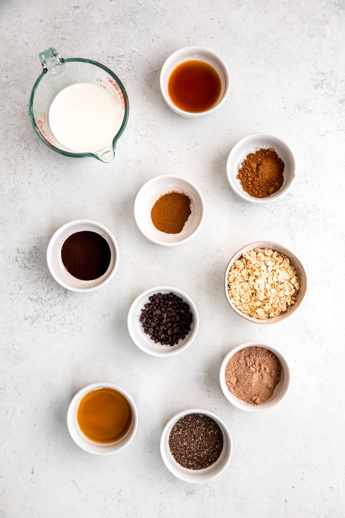 ingredients needed to make high protein mocha overnight oats recipe measured out on a white table.