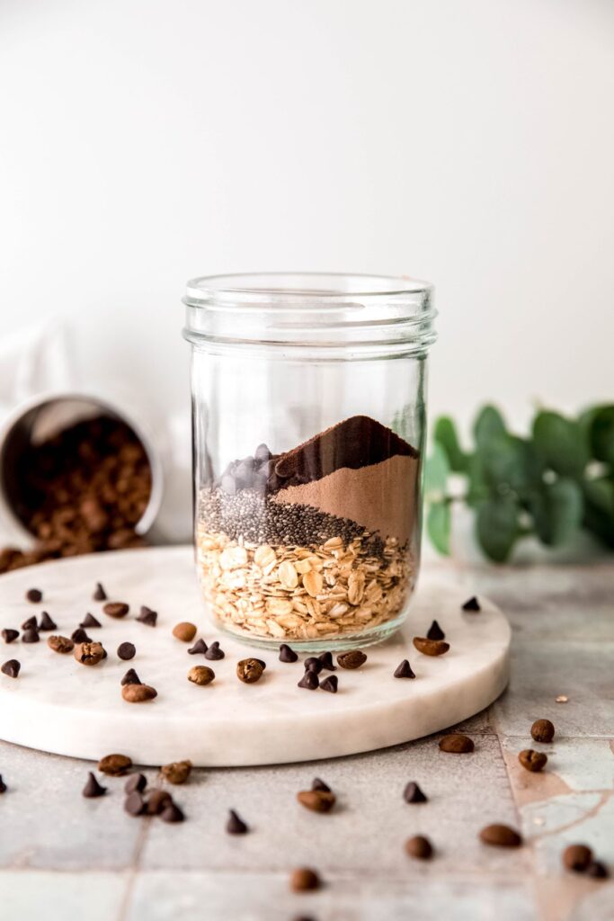 dry overnight oats ingredients added to a pint sized mason jar.