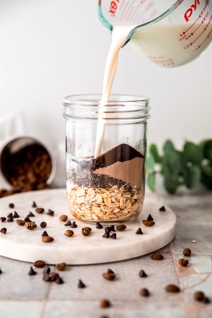 action shot of milk being poured on top of the dried ingredients.