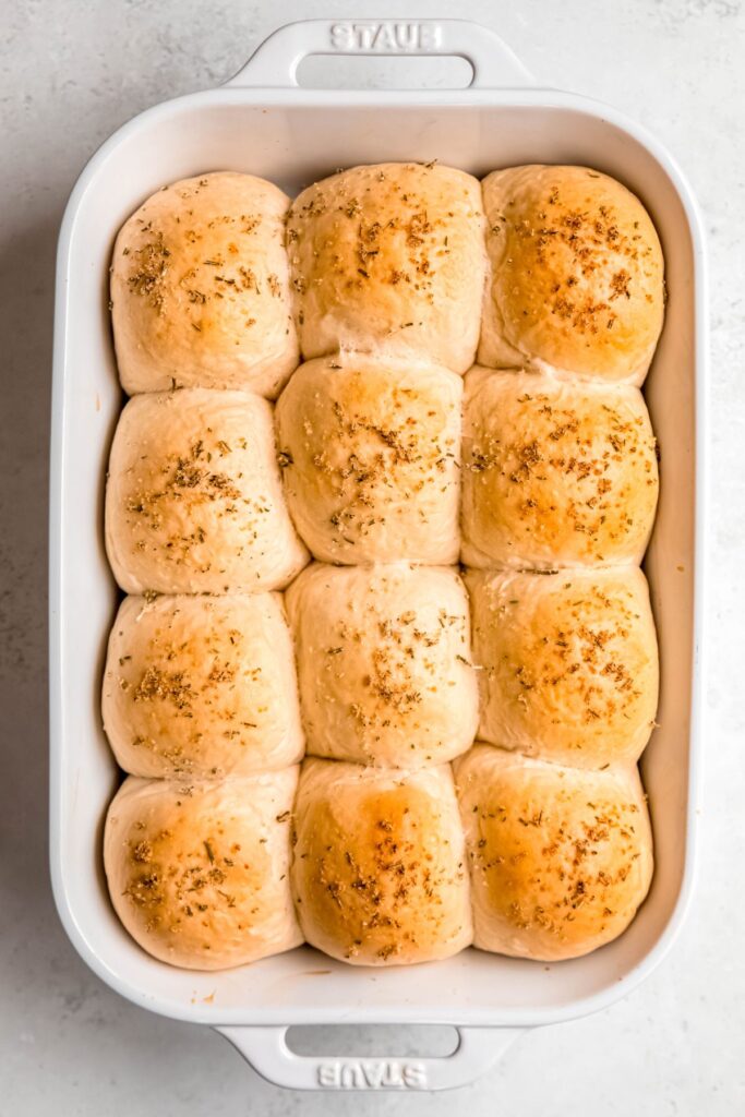 rosemary garlic sourdough discard rolls in the pan after baking until fluffy and golden brown.