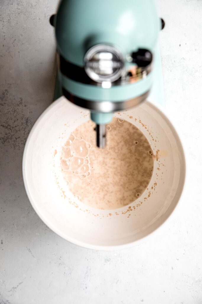 yeast mixture after proofing; there are visible bubbles on top.