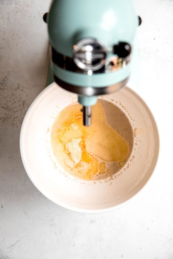 oil and egg added to the yeast mixture in the bowl.