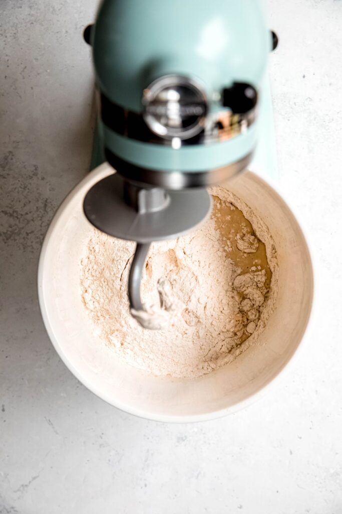 dry ingredients added to the wet ingredients with a dough hook attachment on the stand mixer.