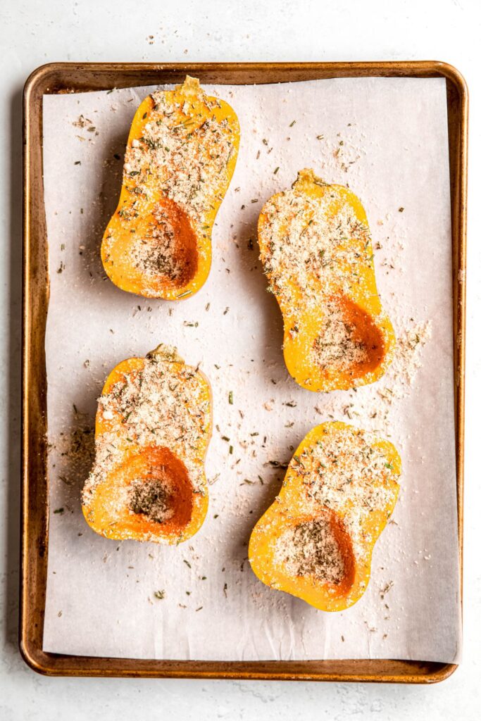 herb and parmesan mixture sprinkled over the oil-brushed honeynut squash.